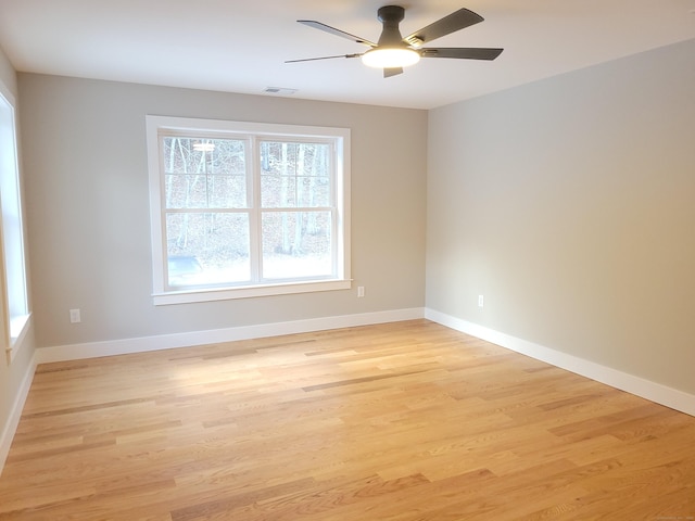 empty room with ceiling fan and light wood-type flooring