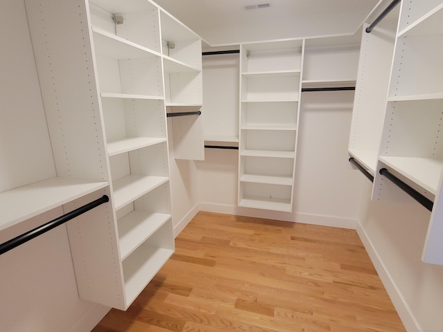 spacious closet featuring light hardwood / wood-style floors