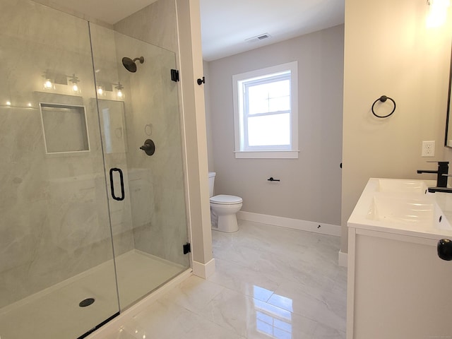 bathroom with walk in shower, vanity, and toilet