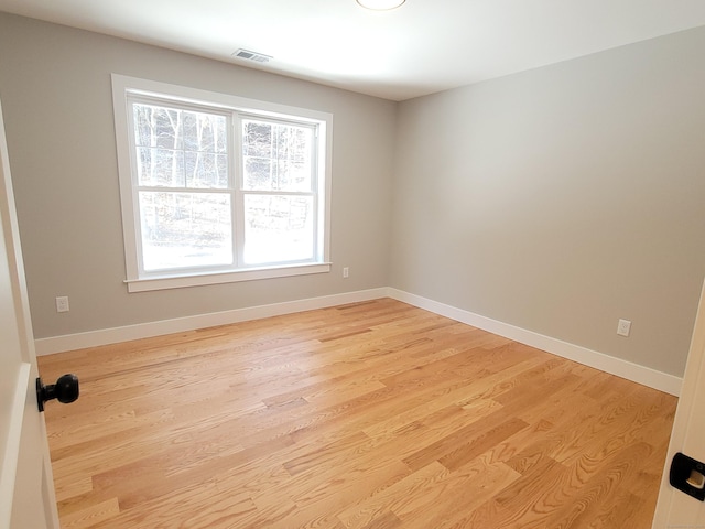 empty room with light hardwood / wood-style floors