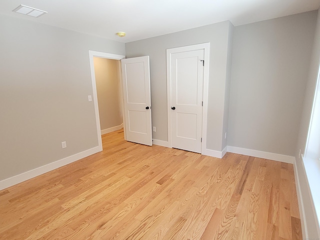 unfurnished bedroom with light wood-type flooring