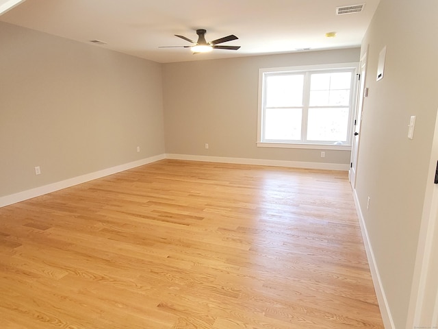 unfurnished room with ceiling fan and light wood-type flooring