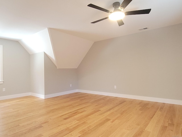 additional living space featuring lofted ceiling, light hardwood / wood-style floors, and ceiling fan