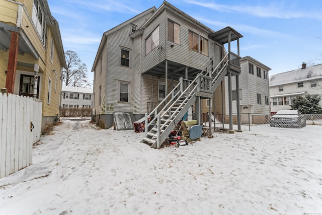 view of snow covered back of property