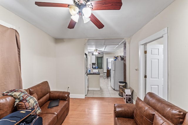 living room with ceiling fan and light hardwood / wood-style floors