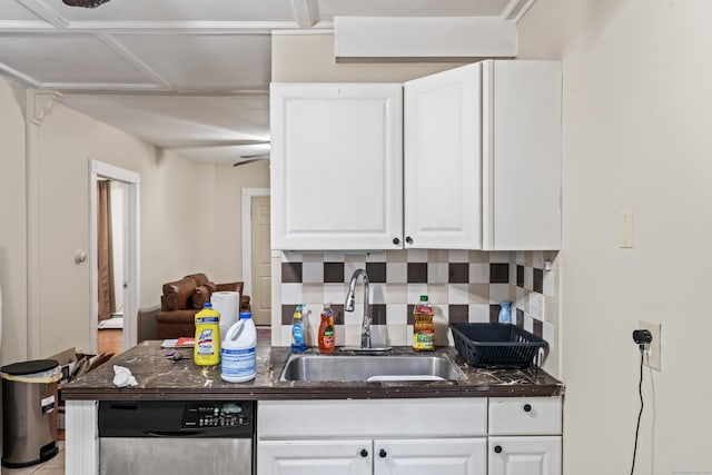 kitchen featuring tasteful backsplash, sink, stainless steel dishwasher, and white cabinets