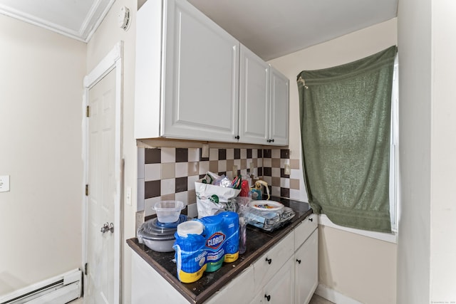 kitchen featuring white cabinetry, crown molding, backsplash, and baseboard heating