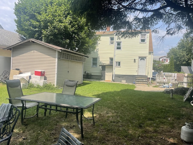 rear view of house featuring a yard