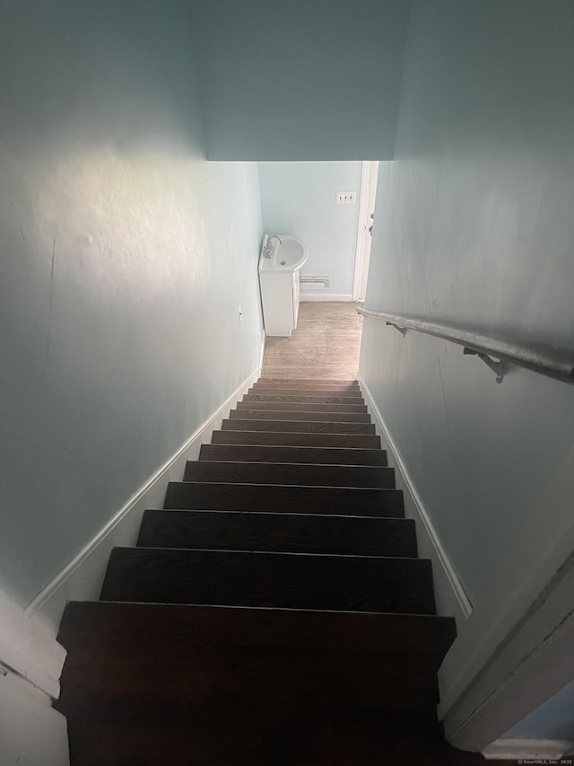 stairway featuring hardwood / wood-style flooring