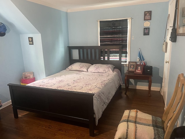 bedroom with ornamental molding and dark wood-type flooring