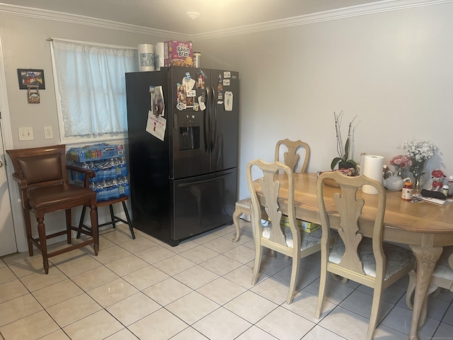 tiled dining room featuring crown molding