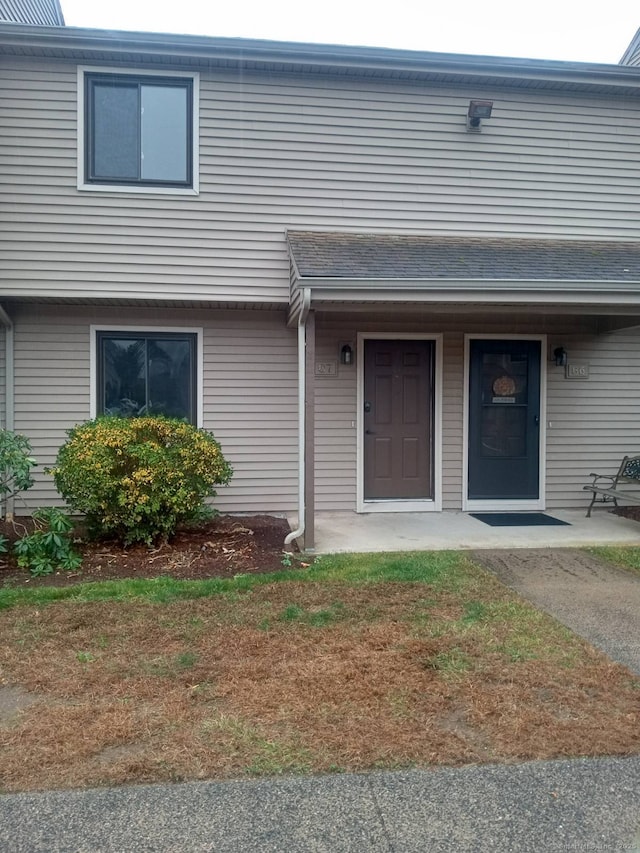 entrance to property featuring a lawn