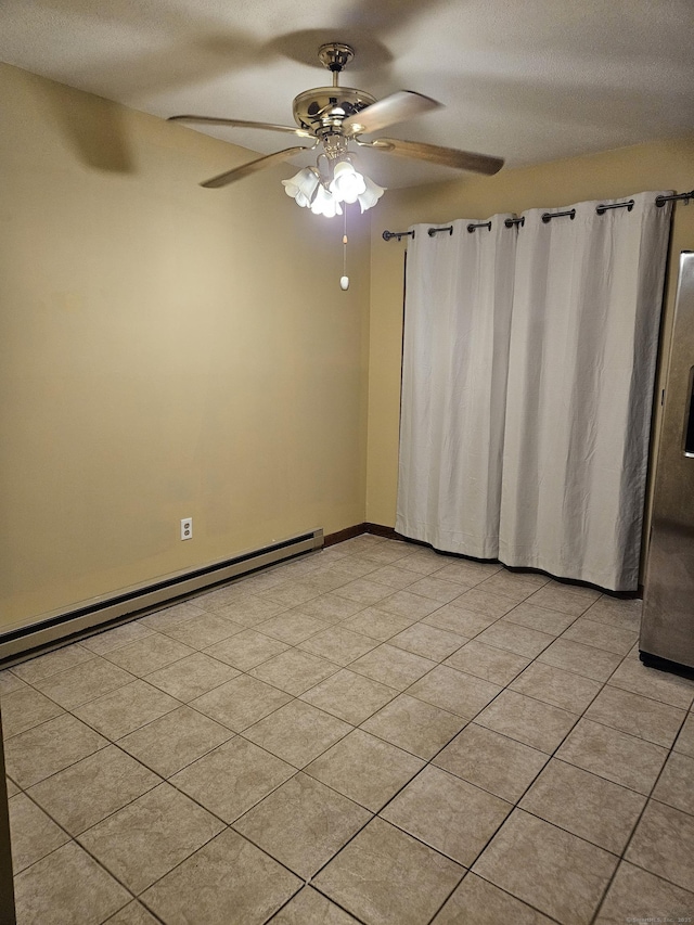 spare room featuring a baseboard heating unit, a textured ceiling, and ceiling fan