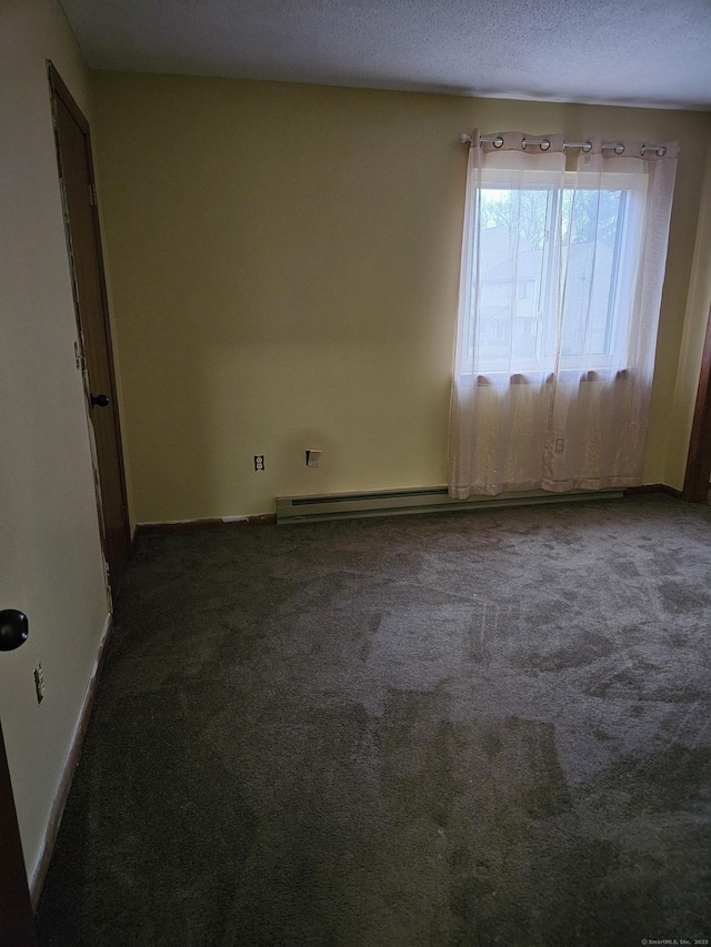 carpeted empty room featuring a textured ceiling