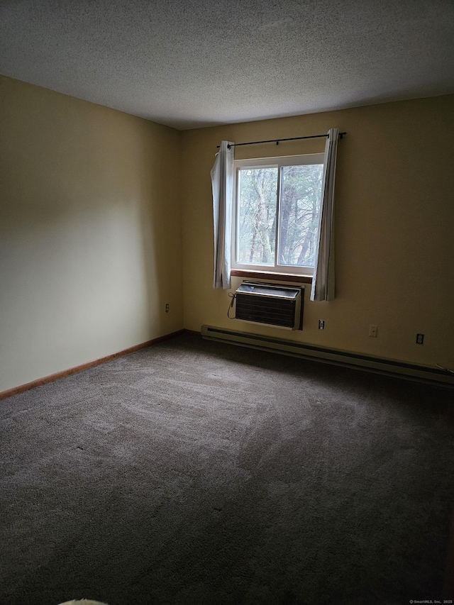 spare room featuring a baseboard heating unit, a wall unit AC, a textured ceiling, and carpet flooring