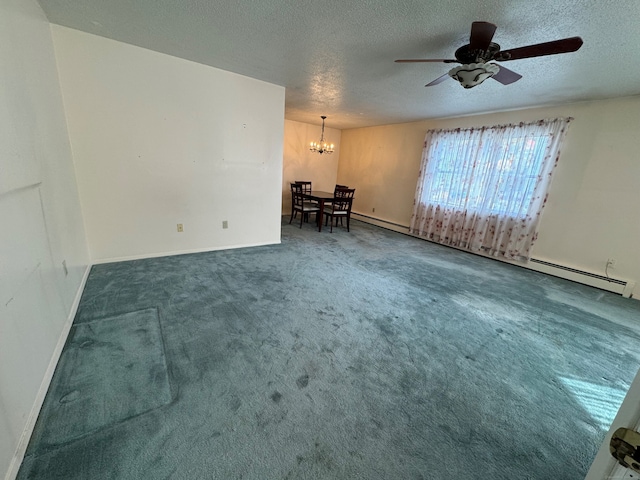 empty room with baseboard heating, ceiling fan with notable chandelier, a textured ceiling, and dark colored carpet