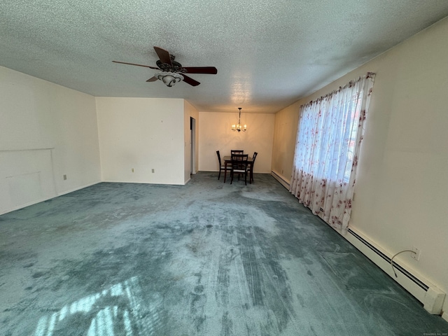 empty room with dark carpet, ceiling fan with notable chandelier, a textured ceiling, and baseboard heating