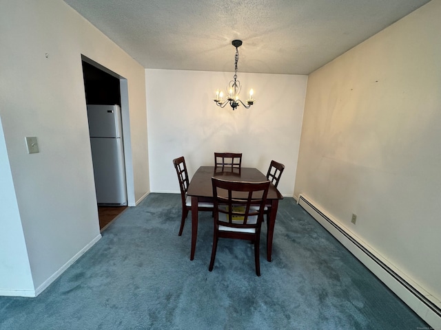 dining area with a baseboard radiator, a textured ceiling, a notable chandelier, and dark carpet