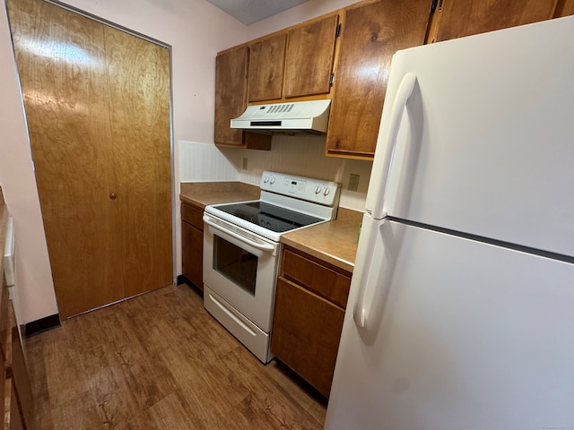 kitchen with white appliances and light wood-type flooring