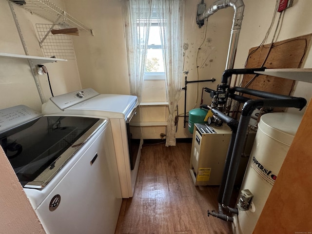 laundry room featuring hardwood / wood-style flooring, washer and dryer, and water heater