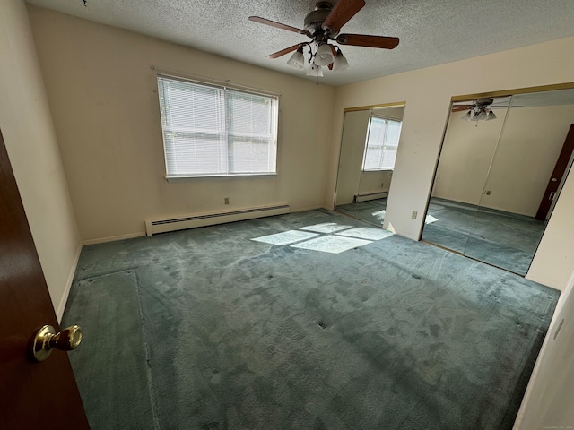 spare room featuring ceiling fan, carpet flooring, a textured ceiling, and baseboard heating