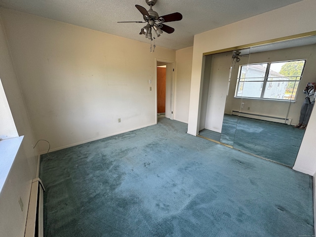 carpeted empty room with ceiling fan, a textured ceiling, and a baseboard heating unit