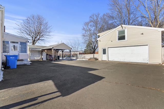 view of side of home featuring a garage and a gazebo