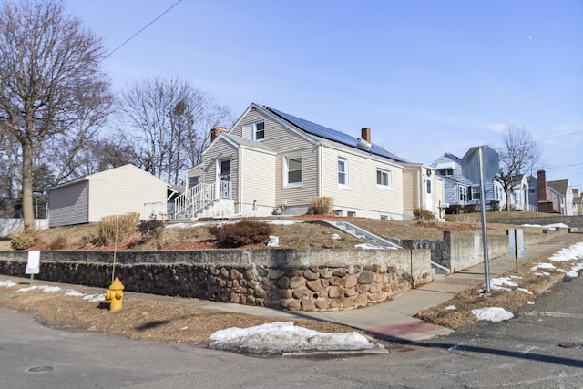 view of property exterior with solar panels