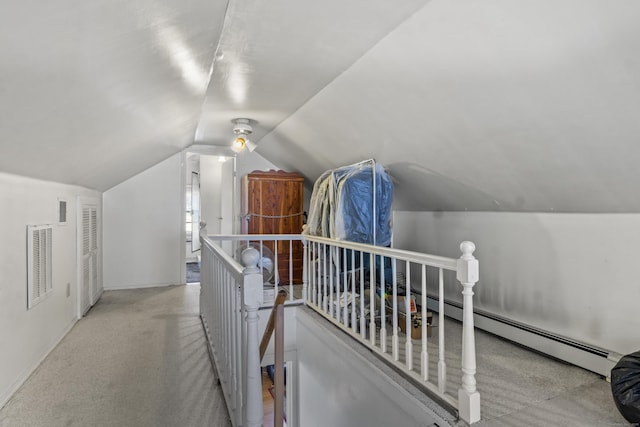 additional living space with light colored carpet, lofted ceiling, and a baseboard radiator