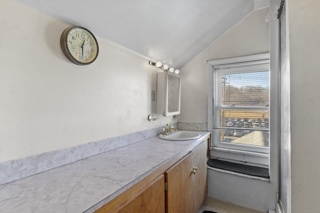 bathroom with vanity and vaulted ceiling