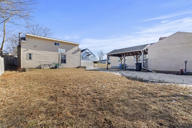 rear view of house featuring a yard and a gazebo