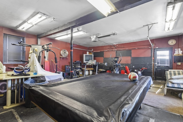 garage with a garage door opener and a workshop area