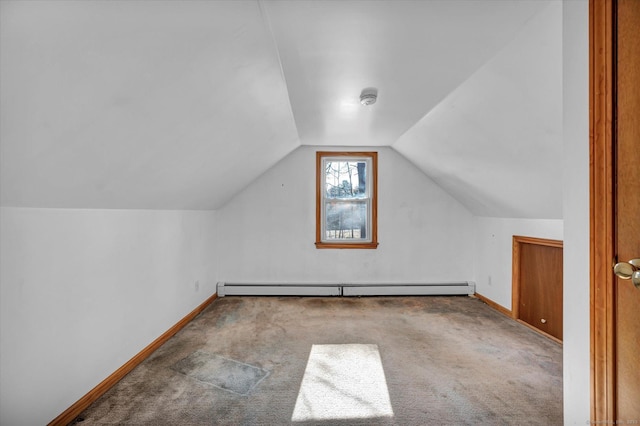 bonus room featuring vaulted ceiling, a baseboard heating unit, and carpet flooring