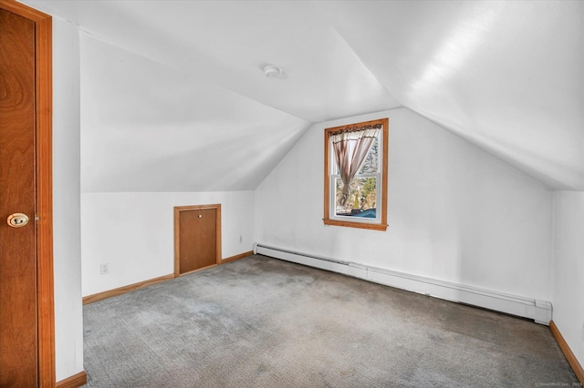 additional living space with lofted ceiling, carpet, and a baseboard heating unit