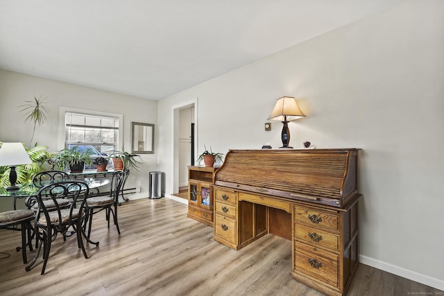 home office with light hardwood / wood-style flooring