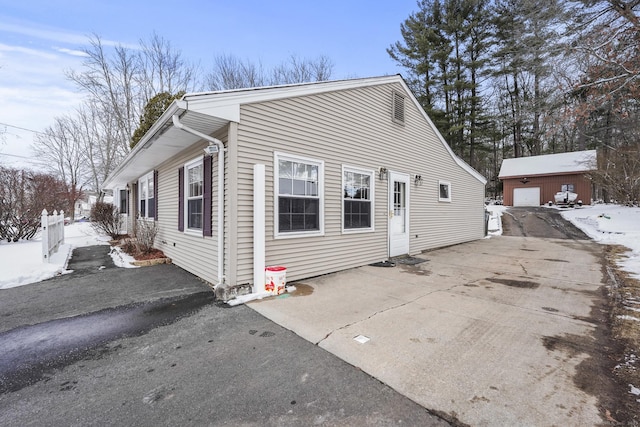 exterior space with an outbuilding and a garage