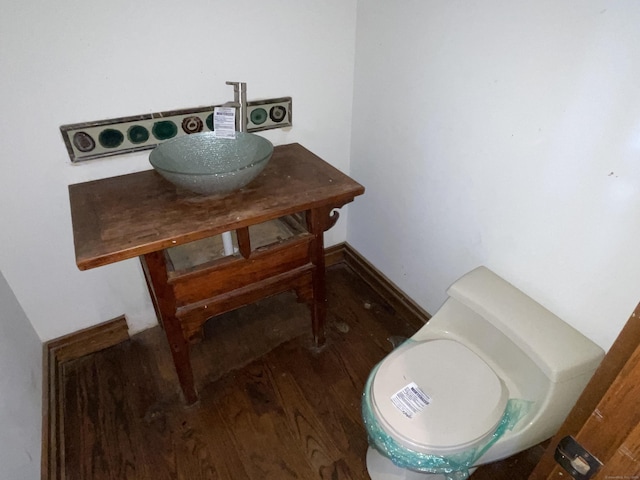 details with sink, hardwood / wood-style flooring, and toilet