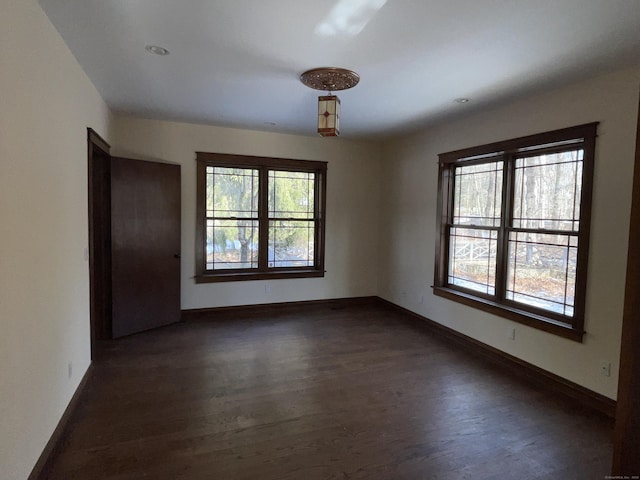 spare room with dark wood-type flooring