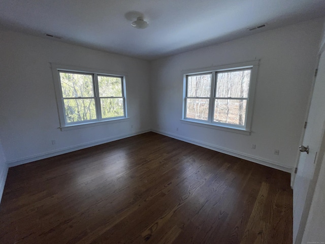 spare room featuring dark hardwood / wood-style flooring