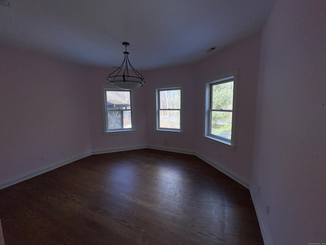 unfurnished room featuring dark hardwood / wood-style flooring