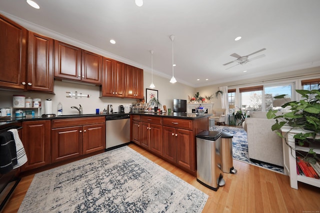 kitchen featuring pendant lighting, dark stone counters, ornamental molding, stainless steel dishwasher, and light wood-type flooring