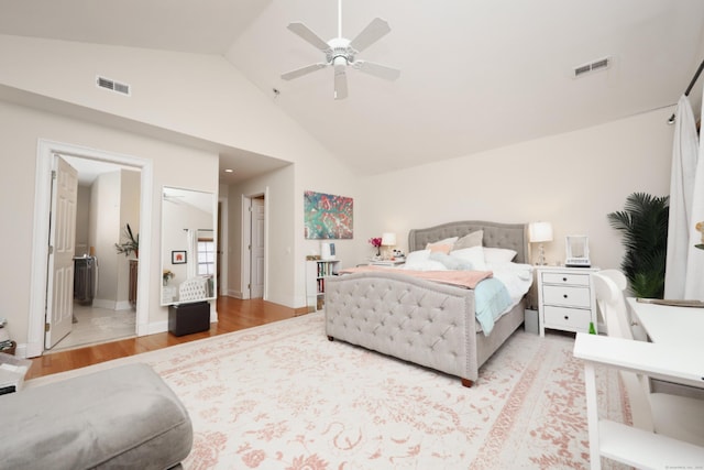 bedroom featuring hardwood / wood-style flooring, ceiling fan, and high vaulted ceiling