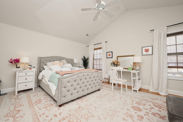 bedroom featuring ceiling fan, lofted ceiling, and light hardwood / wood-style flooring