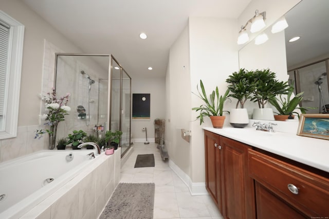 bathroom with vanity and independent shower and bath