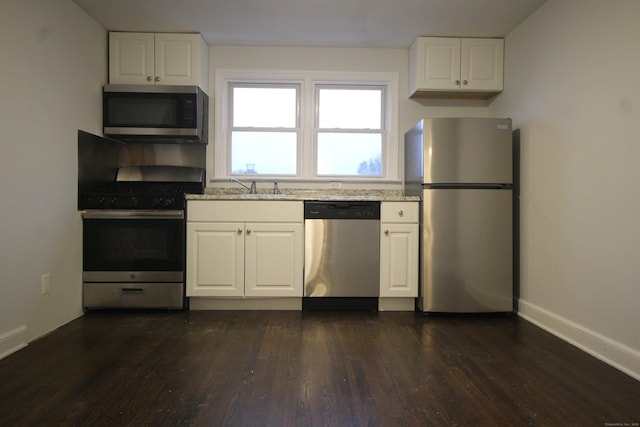 kitchen with white cabinetry, sink, dark hardwood / wood-style flooring, and appliances with stainless steel finishes