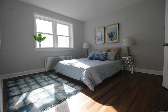 bedroom with radiator and dark wood-type flooring