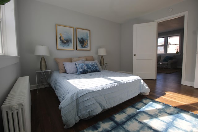 bedroom featuring dark wood-type flooring and radiator heating unit