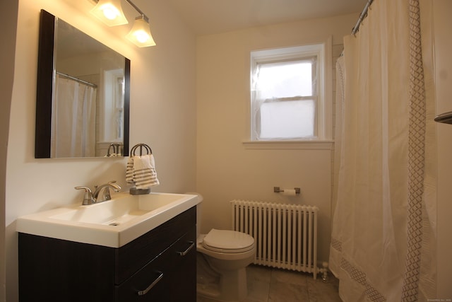 bathroom with vanity, radiator heating unit, tile patterned floors, and toilet