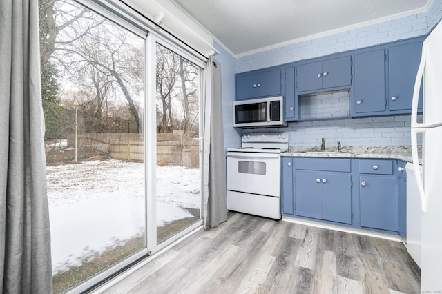 kitchen featuring sink, light hardwood / wood-style floors, crown molding, blue cabinetry, and white appliances