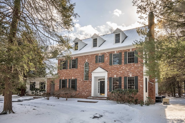 colonial-style house featuring central AC unit